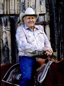 Elderly man in cowboy hat on horse.