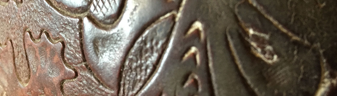 Close-up of textured metallic surface with embossed patterns.